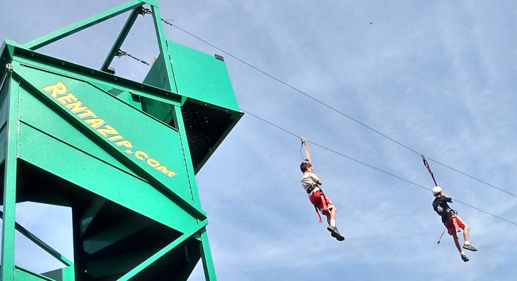 2 kids zip lining on a zip line rental in San Antonio